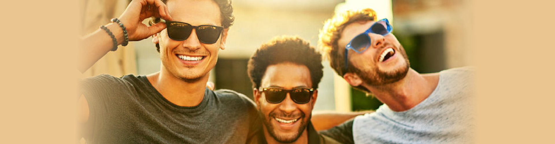 three happy guys in sunglasses